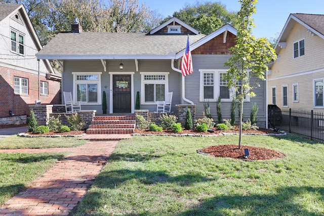 craftsman inspired home with a front lawn