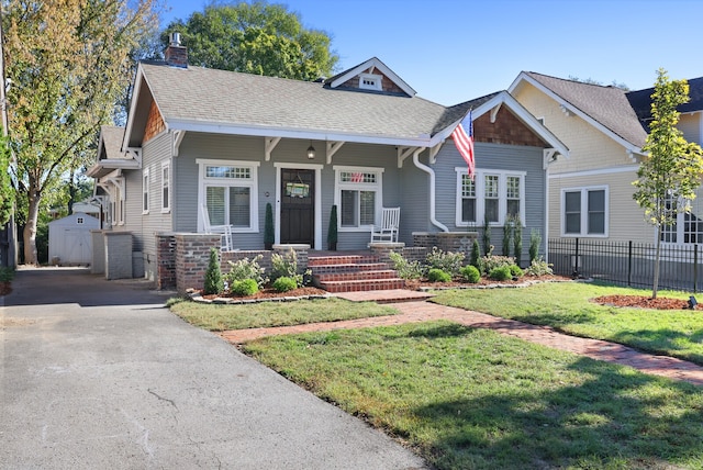 craftsman house with a front yard and a porch