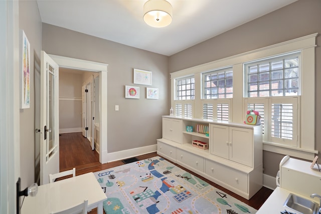 interior space with sink and dark wood-type flooring