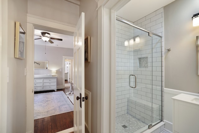 bathroom featuring vanity, hardwood / wood-style floors, walk in shower, and ceiling fan