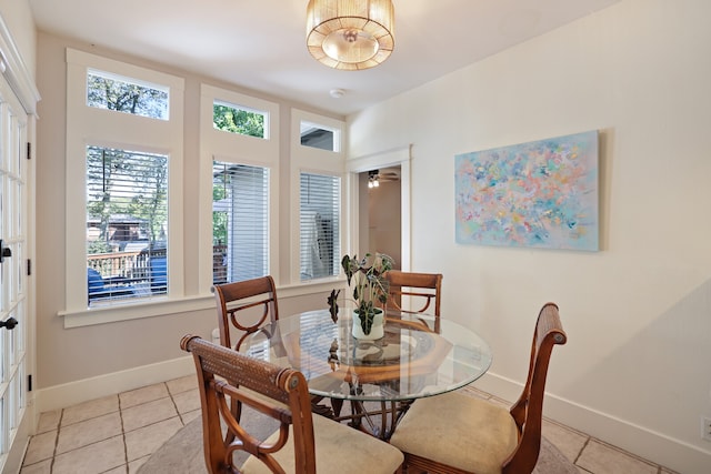 dining area featuring ceiling fan and light tile patterned flooring