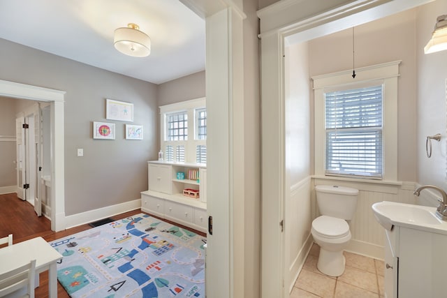 bathroom featuring vanity, toilet, plenty of natural light, and tile patterned flooring