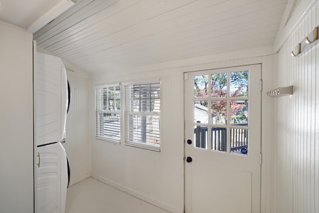 entryway featuring stacked washer / drying machine and plenty of natural light