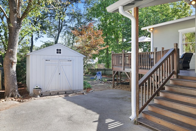 exterior space featuring a deck and a storage unit