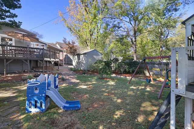 view of yard featuring a playground and a wooden deck