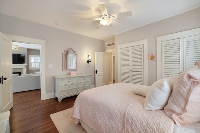 bedroom with dark hardwood / wood-style floors and ceiling fan