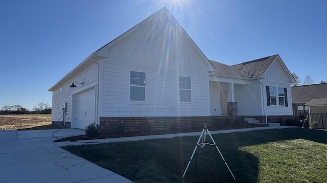 exterior space featuring a garage and a front lawn