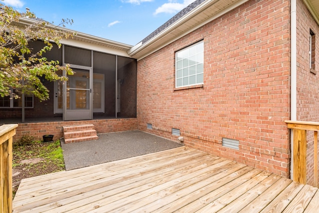 wooden deck featuring a sunroom