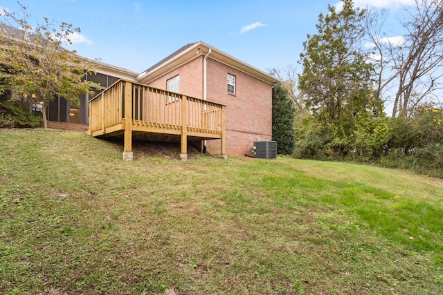 back of house with cooling unit, a yard, and a wooden deck