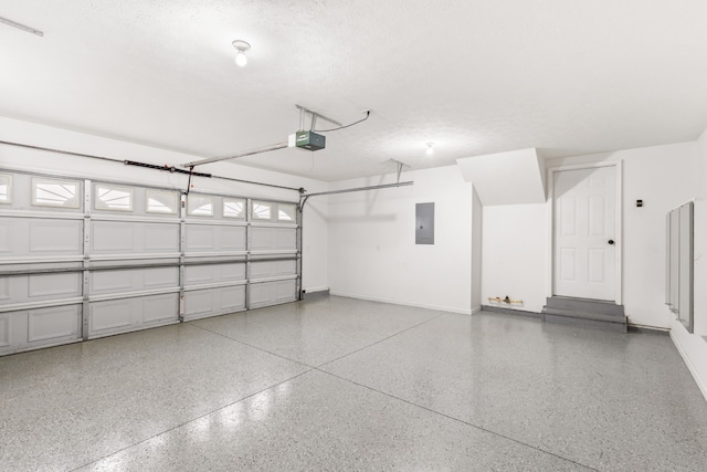 garage with electric panel and a garage door opener