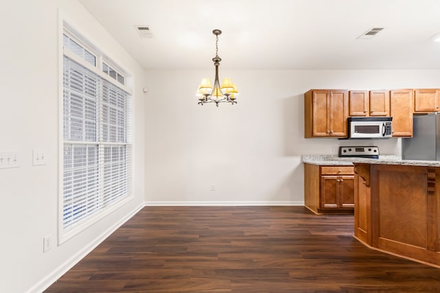 kitchen featuring a chandelier, pendant lighting, range with electric cooktop, and dark wood-type flooring