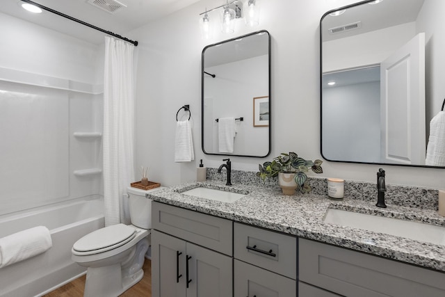 full bathroom featuring toilet, wood-type flooring, vanity, and shower / tub combo with curtain