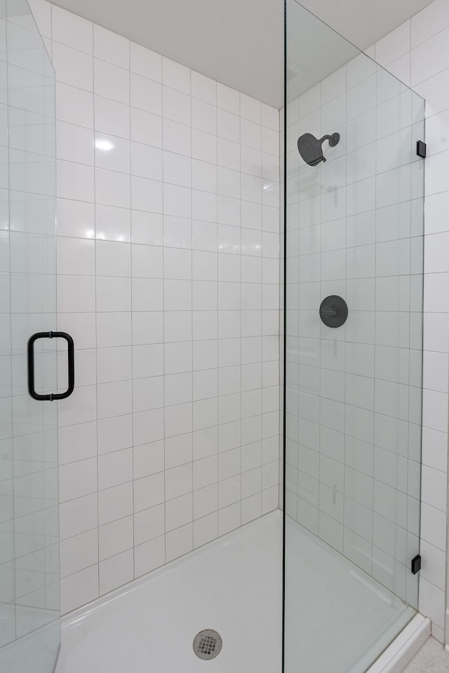 bathroom with a shower with shower door