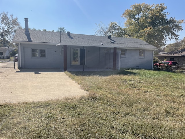 rear view of house featuring a patio and a yard