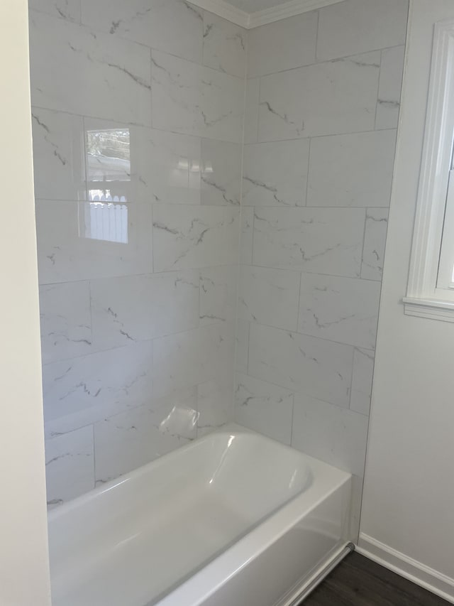 bathroom with tiled shower / bath combo and hardwood / wood-style flooring