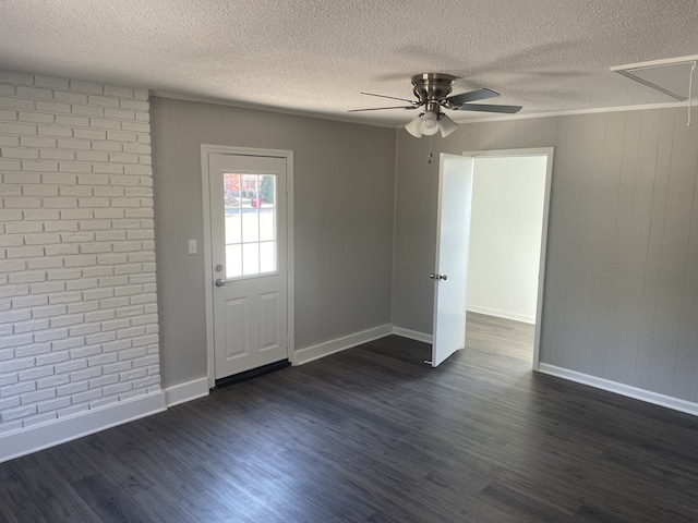 foyer featuring dark wood-type flooring, a textured ceiling, and ceiling fan