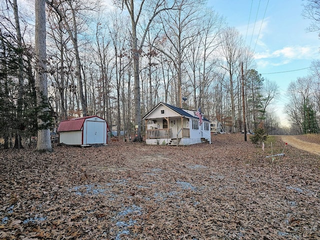 view of yard featuring covered porch and a shed