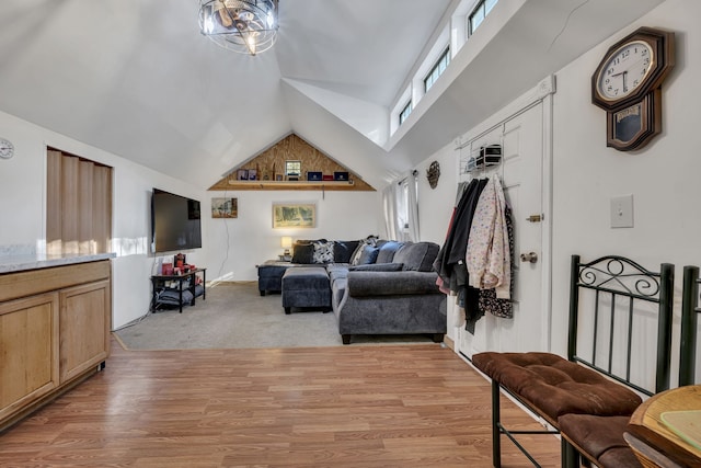 living room with light colored carpet and high vaulted ceiling