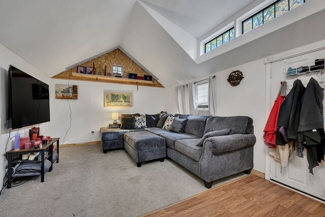 living room with hardwood / wood-style floors and high vaulted ceiling