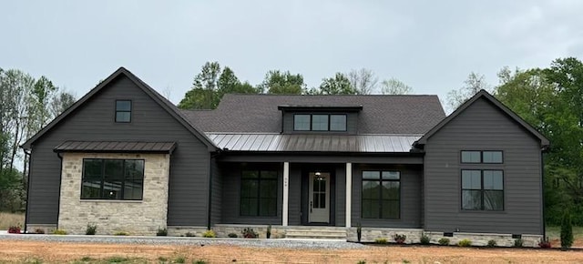 948 Hidden River Rd, Rock Island, TN 38581 - view of front of house featuring a standing seam roof, covered porch, metal roof, and stone siding