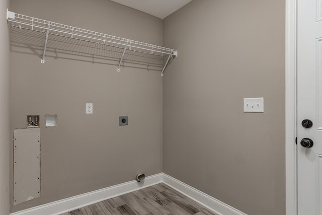 clothes washing area with hookup for an electric dryer, wood-type flooring, and washer hookup