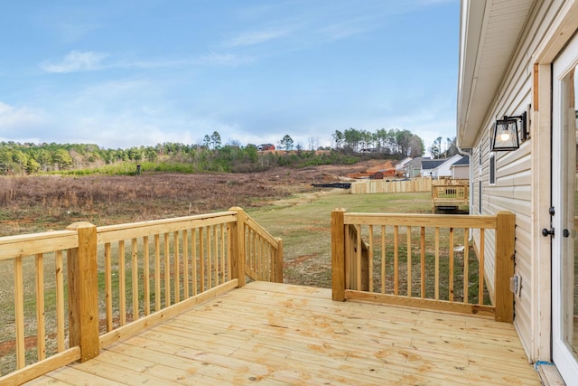 wooden terrace featuring a yard