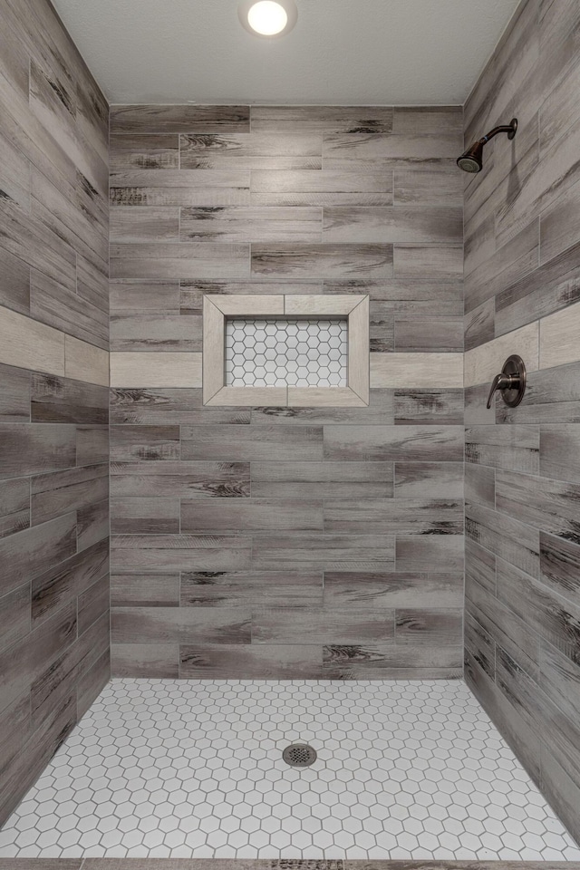 bathroom with a tile shower