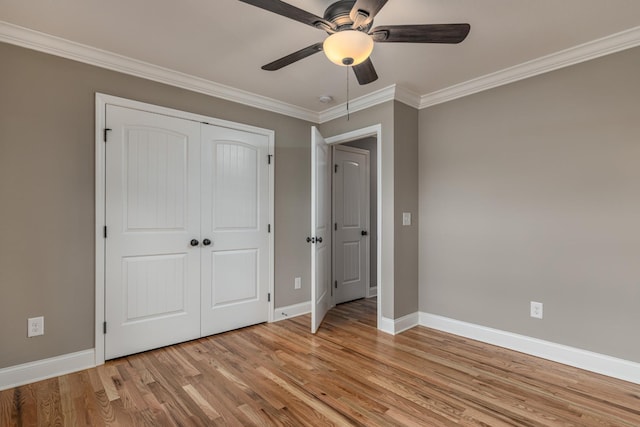 unfurnished bedroom with a closet, light hardwood / wood-style flooring, ceiling fan, and ornamental molding