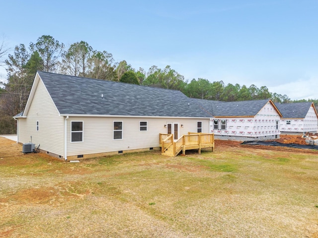 back of house featuring central air condition unit, a lawn, and a deck