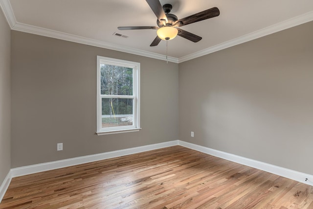 empty room with ceiling fan, crown molding, and light hardwood / wood-style flooring