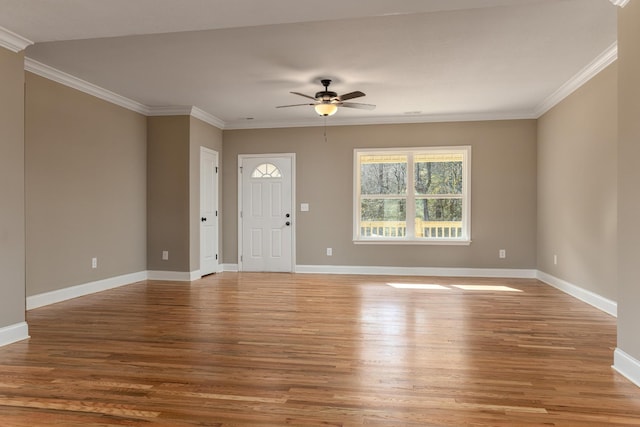 interior space with hardwood / wood-style flooring, ceiling fan, and crown molding