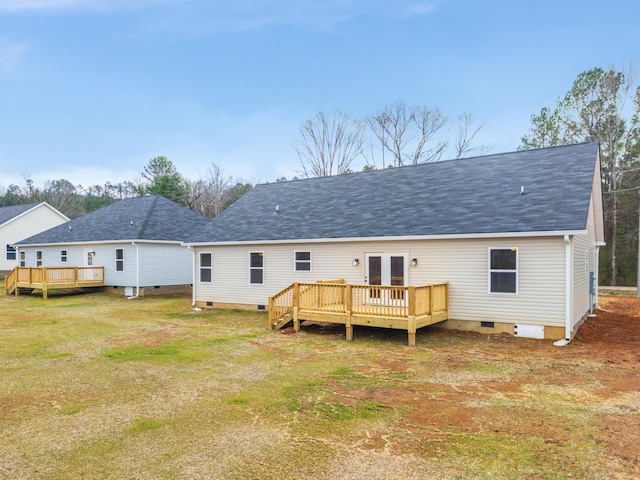 back of property featuring a lawn, a deck, and french doors