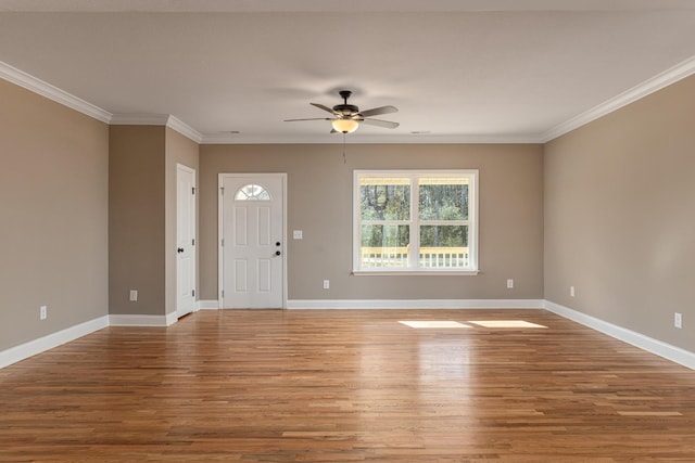 foyer entrance with hardwood / wood-style flooring, ceiling fan, and crown molding