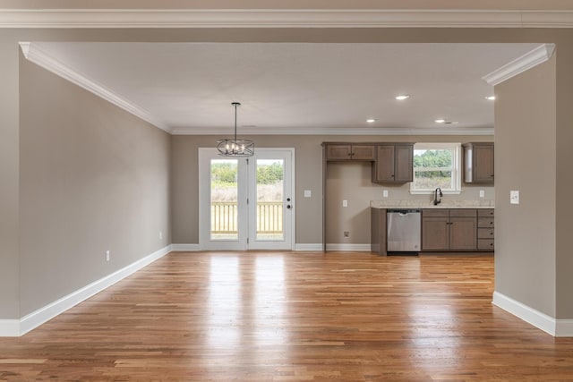 kitchen featuring sink, an inviting chandelier, stainless steel dishwasher, and ornamental molding