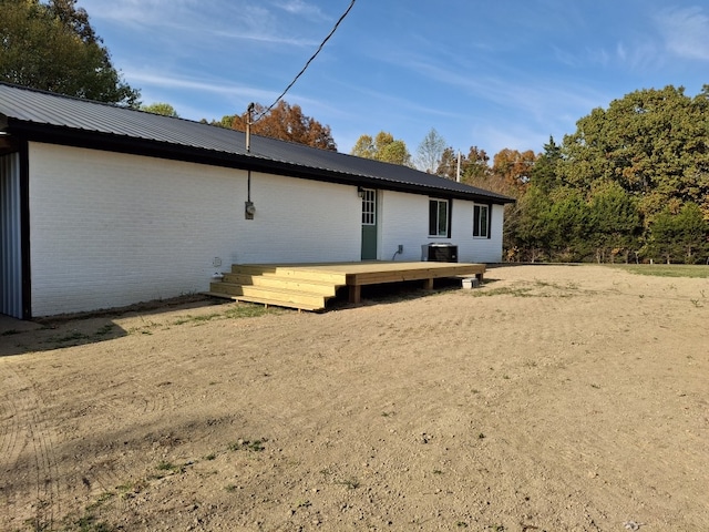 back of house featuring a deck and central AC unit