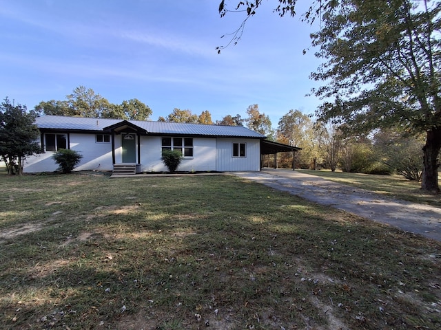 ranch-style house featuring a carport and a front yard