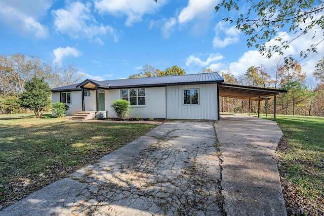 single story home with a front lawn and a carport