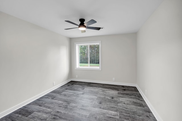 empty room with dark wood-type flooring and ceiling fan