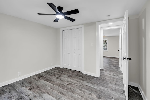 unfurnished bedroom with hardwood / wood-style floors, ceiling fan, and a closet