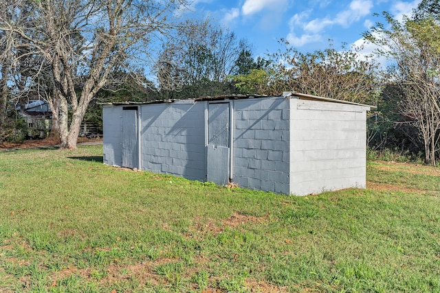 view of outdoor structure with a lawn