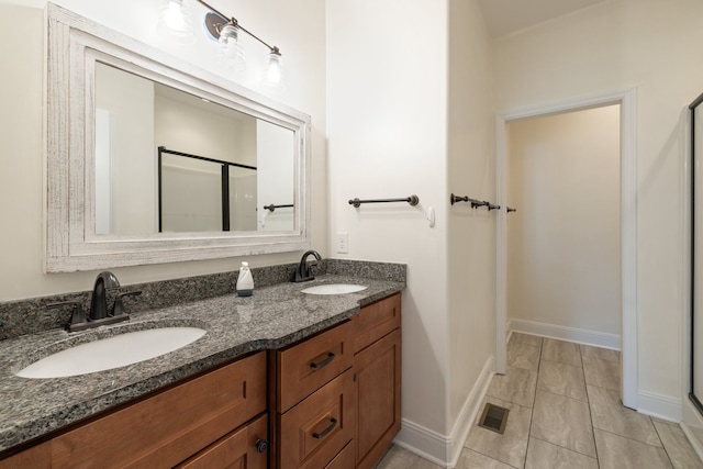 bathroom with vanity, walk in shower, and tile patterned flooring