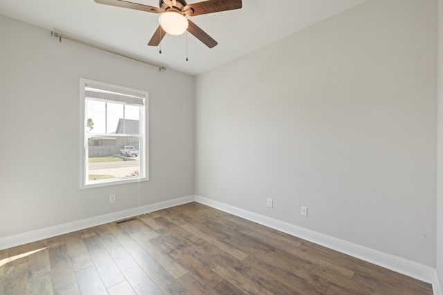 spare room featuring hardwood / wood-style floors and ceiling fan