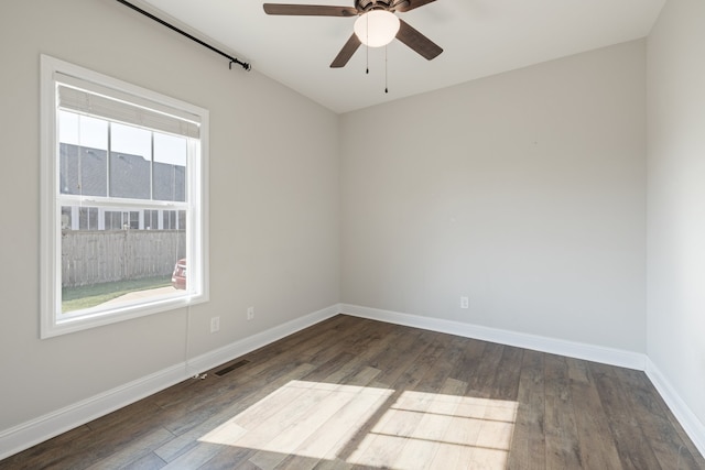 empty room featuring ceiling fan and dark hardwood / wood-style flooring