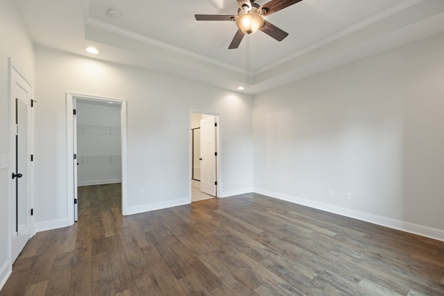 unfurnished room with crown molding, dark hardwood / wood-style floors, and ceiling fan