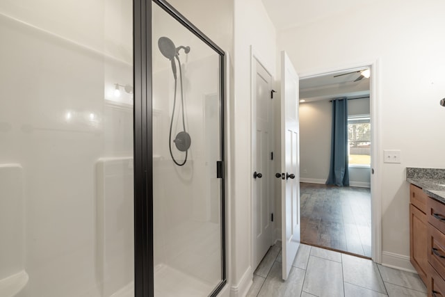 bathroom featuring vanity, hardwood / wood-style floors, and walk in shower