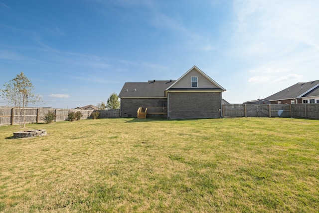 back of property featuring a lawn