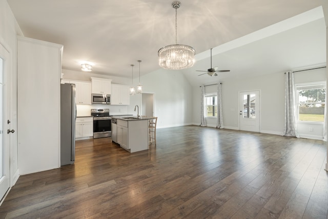 kitchen with appliances with stainless steel finishes, sink, white cabinetry, lofted ceiling, and a center island with sink