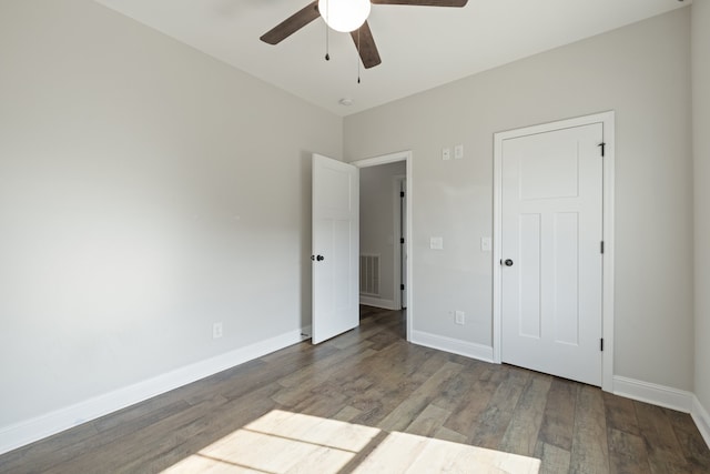 unfurnished bedroom featuring hardwood / wood-style floors and ceiling fan