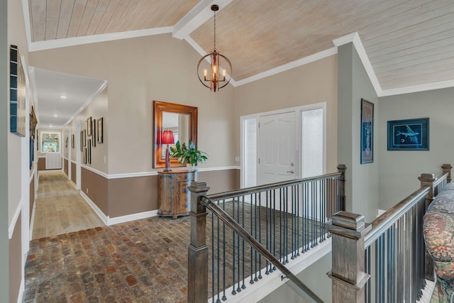 hallway featuring wood ceiling, crown molding, lofted ceiling with beams, and a chandelier