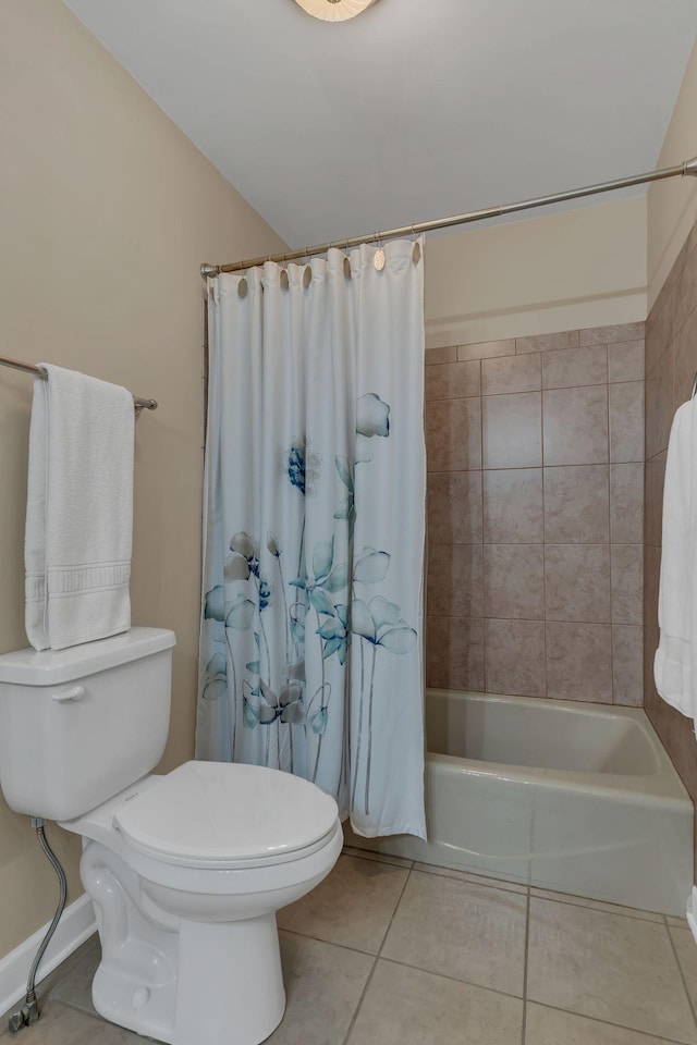 bathroom with tile patterned flooring, shower / bath combo, and toilet